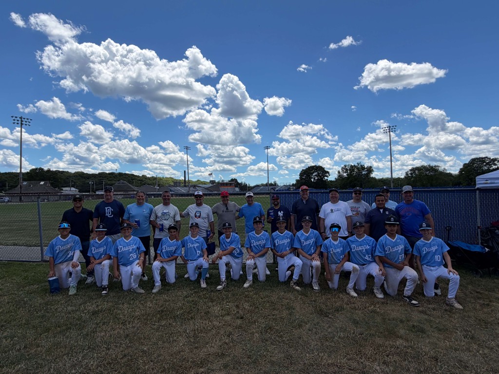 The Dawgs youth baseball team and coaches posing on the field